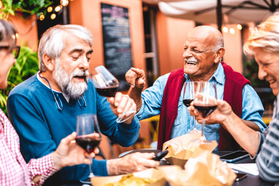 Elderly men drinking wine